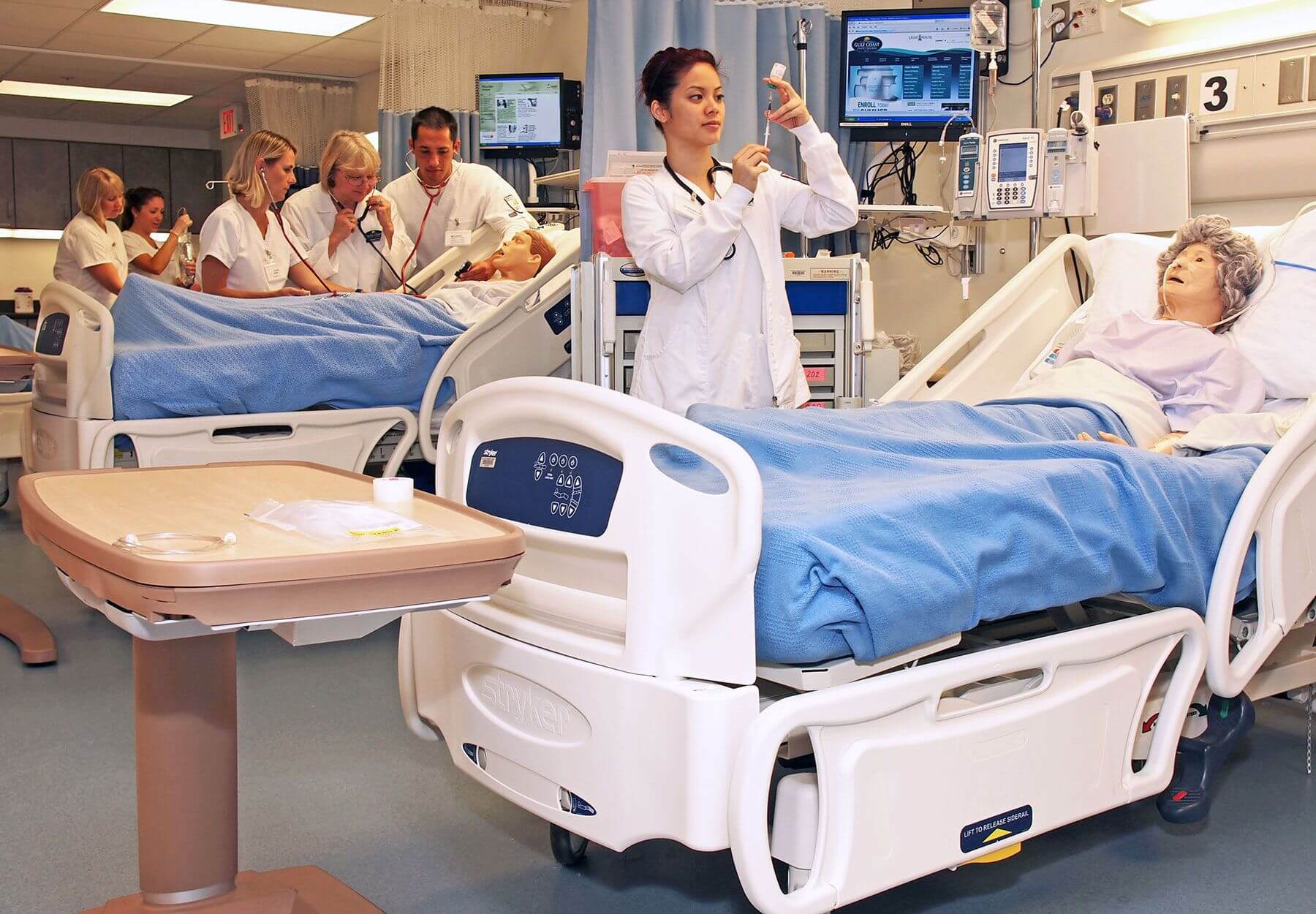 Nursing students practice administering care to patients.