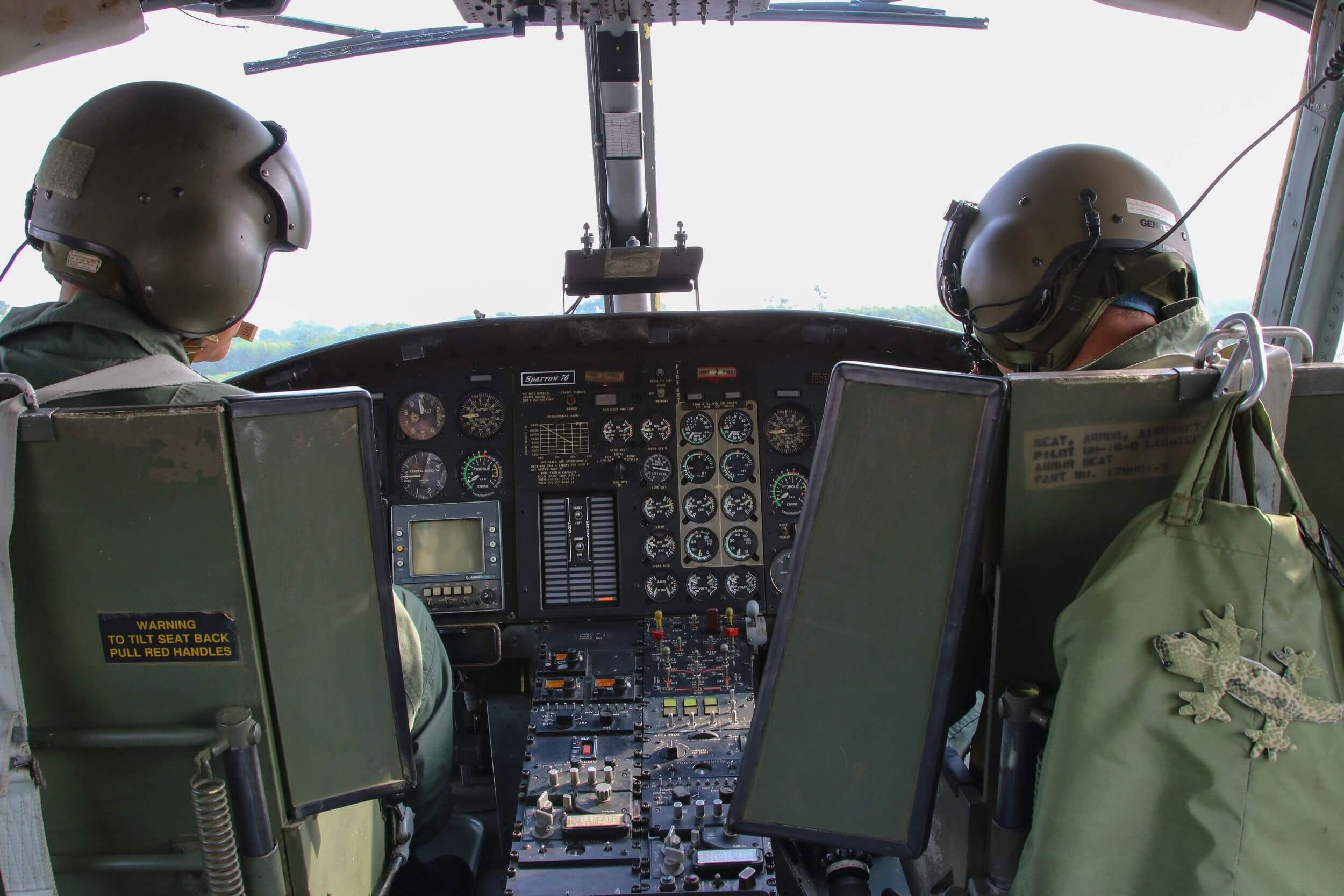 Two airforce pilots sitting in helicopter cockpit.