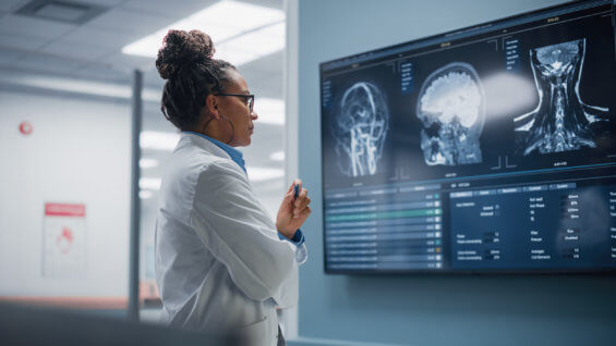 Female Neurologist looking MRI scan of brain imaging.